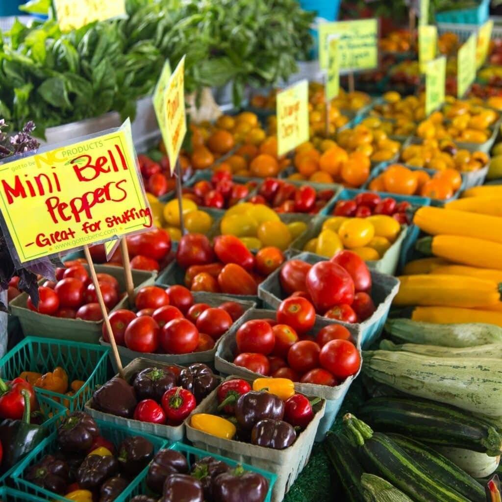 Colorful assortment of fresh vegetables at an outdoor farmers market in North Carolina.