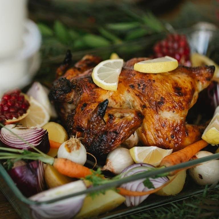 Gourmet meals at home: Delicious roast chicken surrounded by fresh vegetables, perfect for a holiday feast.